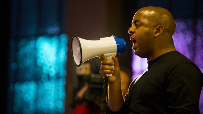 The Rev. Jarrett Maupin, a Phoenix leader in the black community, speaks at Civic Space Park during a rally/march to Phoenix police headquarters, Dec. 4, 2014, to protest the fatal shooting of Rumain Brisbon, an unarmed black man who was shot by a Phoenix police officer.