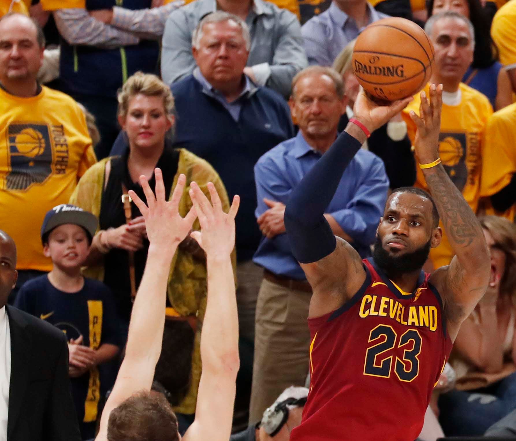Cleveland Cavaliers forward LeBron James makes a three-point shot against Indiana Pacers forward Bojan Bogdanovic during the 4th quarter in Game 3.