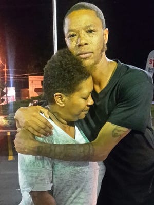 Chelsea Outlaw hugs his mother, Alexis, after being released from the James T. Vaughn Correctional Center in Smyrna. City police have dropped charges accusing him of shooting a 6-year-old boy.