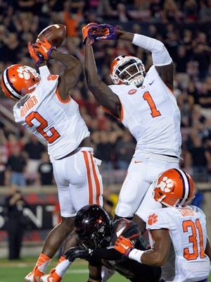 Clemson Tigers cornerback Mackensie Alexander (2) and safety Jayron Kearse (1) battle for a pass intended for Louisville Cardinals wide receiver Traveon Samuel (9) in the finals seconds of the second half at Papa John's Cardinal Stadium. Clemson defeated Louisville 20-17.  Mandatory Credit: Jamie Rhodes-USA TODAY Sports