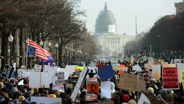 Crowds chant "Don't shoot" and "I can't breathe" ...