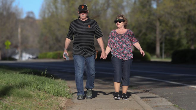 David Rose and his wife Pamela walk along Quartz Hill Road Tuesday. Construction crews this summer will install crosswalk upgrades in front of Caldwell Park and plan to widen a narrow stretch of the road to the northwest.