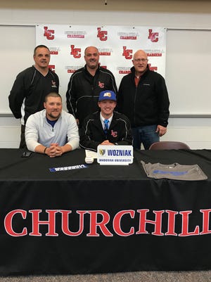 Livonia Churchill senior Joe Wozniak recently signed to play baseball at Madonna University. In the front row (from left) are Madonna baseball coach Ted Falkner and Wozniak. Standing (from left) are Churchill baseball coach Ron Targosz, dad Mike Wozniak and travel baseball coach Mike Granzotto.
