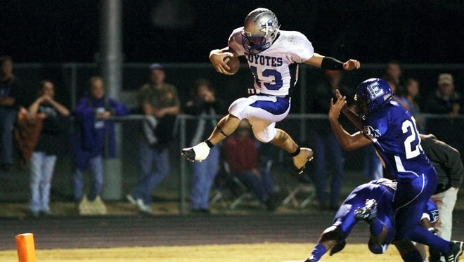 Richland Springs' Tyler Ethridge leaps over Eden defenders for a touchdown in a game Nov. 2, 2007.