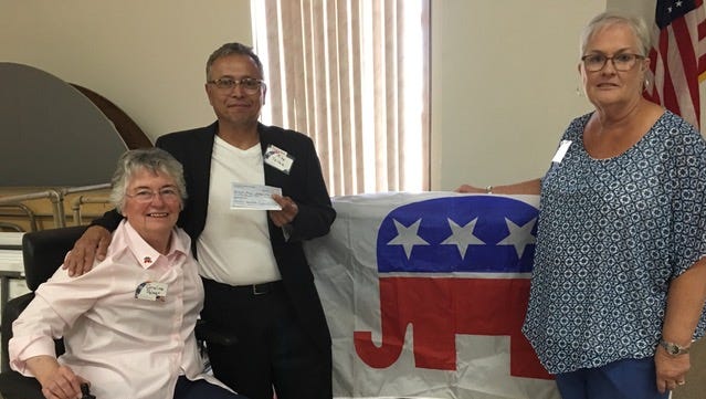 Dream Center founder Mike Tellez, center, received a donation from the Doña Ana County Federated Republican Women in 2017.