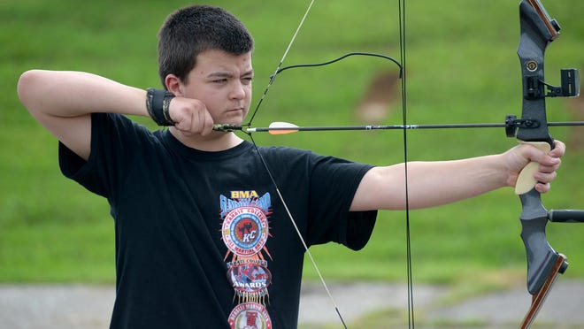 Josh Nichols prepares to fire an arrow at a target last week at Kenpo Karate summer camp.