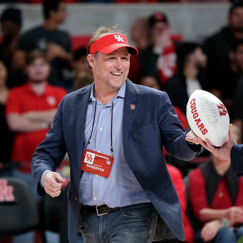 Dana Holgorsen gets autographed footballs to toss...