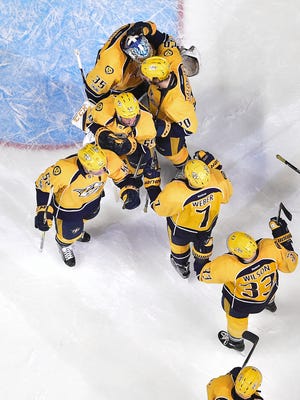 Predators teammates congratulate goalie Pekka Rinne (35) after their 3-1 victory over the Blues in Game 3 on Sunday, April 30, 2017.