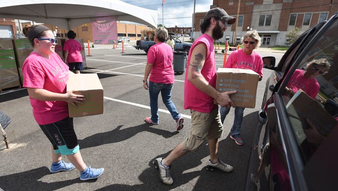 An army of volunteers from Avon loaded up cars, trucks and vans with boxes of food and hygene products during the Feed the Children program on Friday. More than 800 families were helped by the program, which is a partnership with Christ's Table.