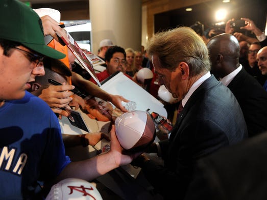 Alabama head coach Nick Saban signs autographs at SEC