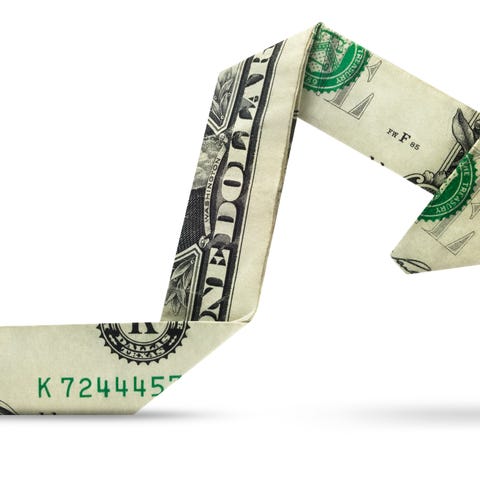 A dollar bill folded origami-style into an arrow p