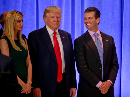 Donald Trump waits with daughter Ivanka Trump and son Donald Trump Jr. before speaking at a news conference on Jan. 11, 2017, in New York.