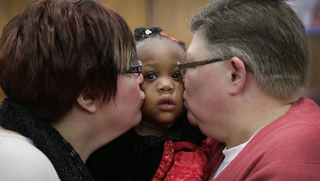April DeBoer, 43, left, and Jayne Rowse, 50, of Hazel Park, Mich., attend Michigan Adoption Day with their family to finalize their fourth adoption of 28-month-old Rylee DeBoer-Rowse, on Nov. 25, 2014, at the Oakland County Courthouse in Pontiac, Mich. DeBoer and her partner Rowse are plaintiffs battling for marriage equality in Michigan.