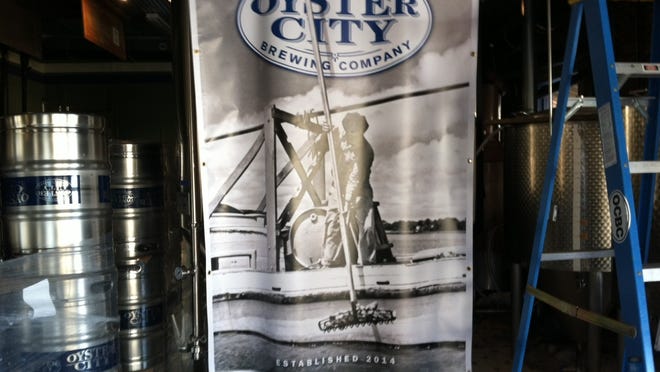 An Oyster City Brewing Co. banner is draped over kegs in the tasting room on Avenue D in Apalachicola.