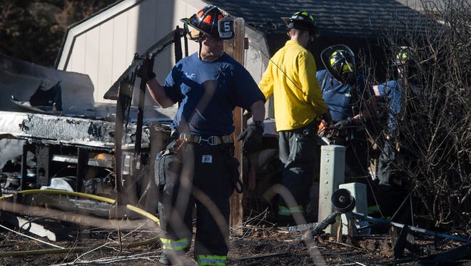 Crews work to clean up after a fire burned fences, four sheds and partially damaged a home on CR 38E west of Taft Hill Road on Thursday, February 16, 2017. The cause of the fire is yet to be determined. 