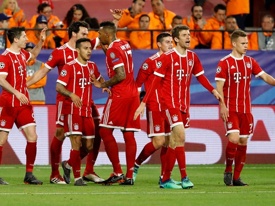 Bayern's Thiago, 3rd left, celebrates with team mates after scoring his side's second goal during the Champions League quarter final first leg soccer match between Sevilla FC and FC Bayern Munich at the Sanchez Pizjuan stadium in Seville, Spain, Tuesday, April 3, 2018. (AP Photo/Miguel Morenatti)