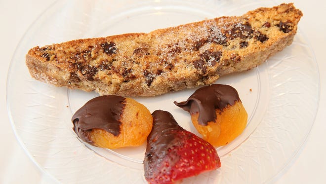This mandelbread, served here with chocolate-coated dried apricots and strawberry, is chock-full of chocolate chips and coated with cinnamon sugar.