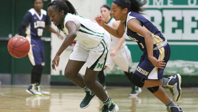 Fort Myers Autumn Giles (21) and Leigh's Halley Holloway (11) go after a loose ball during the ladies basketball game at Fort Myers High School in Fort Myers, FL on Friday, January 29, 2016.  Fort Myers defeated Lehigh to win the Deistrict 6A-11 Championship.  Photo by Gregg Pachkowski