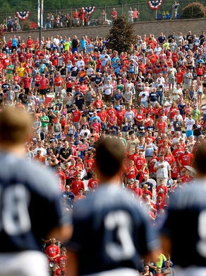 "Members of the Red Land team and thousands of spectators on the hill outside Lamade Stadium stand for the national anthem Saturday, Aug. 29, 2015, during the Little League World Series U.S. championship game featuring Red Land Little League of Pennsylvania and Pearland West Little League of Texas, in South Williamsport. Red Land defeated Pearland 3-2 in a walk-off victory to move on to the world championship game against Tokyo Kitasuna of Japan.