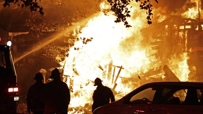 Despite volunteers best efforts, homes being watched over by Angel's Night workers suffer some losses. Fire department crew members fight to extinguish this home located at 776 Algonquin Street on Detroit's East side on Wednesday, Oct. 30, 2013. Jarrad Henderson/Detroit Free Press