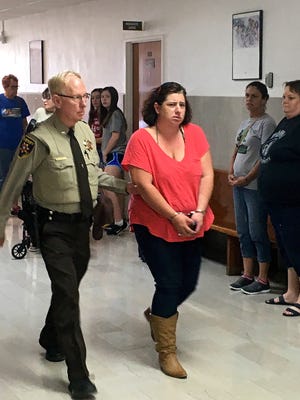 Ashley Rae Kraning is escorted to the Wichita County Jail Tuesday as representatives from several animal welfare groups look on. Kraning was sentenced to 30 days in custody for cruelty to non-livestock animals.