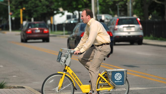 A rider heads up Alabama Street on a Pacers Bikeshare bicycle Monday June 30, 2014.