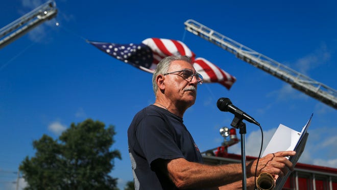Richard Bowyer speaks during a 9-11 memorial service outside the Vintage Fire Museum in Jeffersonville Saturday morning. Around 25 people attended.