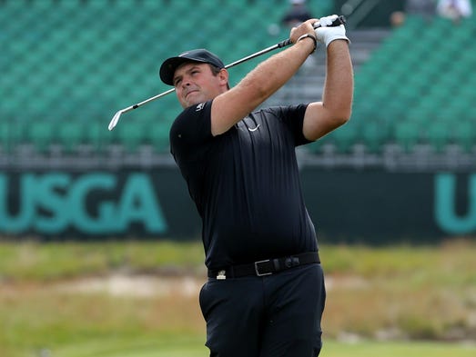 Patrick Reed follows through on a shot from the 17th