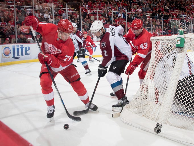 Detroit center Dylan Larkin, left, and center Darren