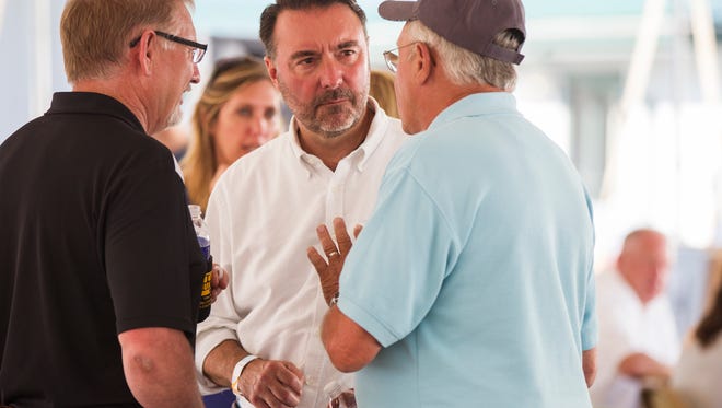 Christopher Peters talks with supporters during a Johnson County Agricultural Association tractor pull on Saturday, July 21, 2018, at the Johnson County Fairgrounds in Iowa City, Iowa. Peters is running for the second district seat against incumbent Dave Loebsack.