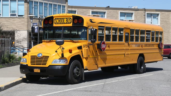 In this file photo on May 9, 2018, a school bus waits outside John Jay High School.