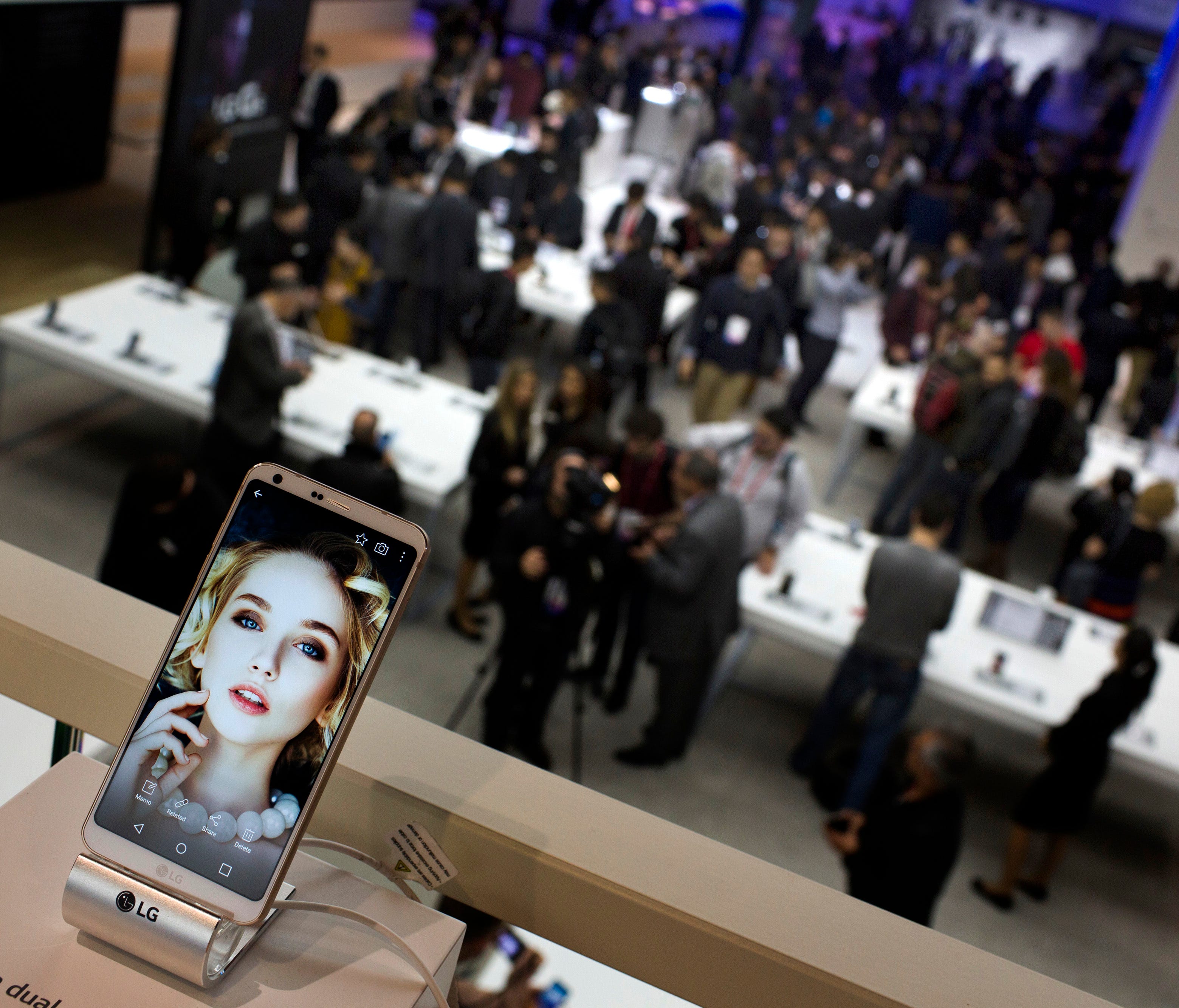 People crowd at the LG stand during the Mobile World Congress wireless show in Barcelona, Spain,