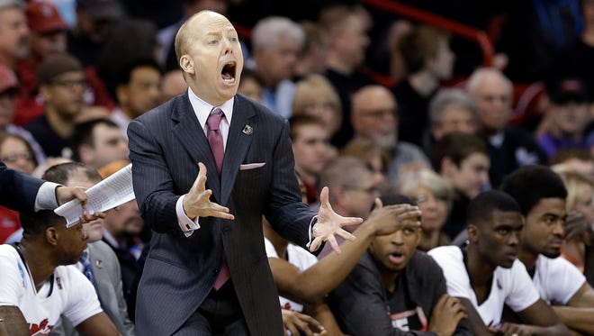 FILE - In this March 20, 2014, file photo, Cincinnati head coach Mick Cronin reacts to a call in favor of Harvard during the second half in the second round of the NCAA college basketball tournament in Spokane, Wash. Cronin will not work games or practices for the rest of the season because of an artery problem.  (AP Photo/Elaine Thompson, File)