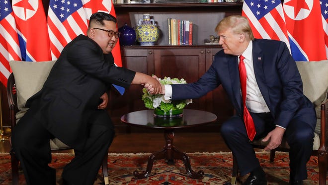 President Trump shakes hands with North Korea leader Kim Jong Un during their first meetings at the Capella resort on Sentosa Island in Singapore.