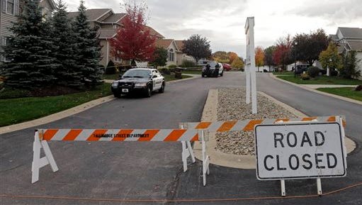 Tallmadge police cordon off a home in Tallmadge, Ohio, Wednesday, Oct. 15, 2014, where Amber Joy Vinson stayed over the weekend before flying home to Dallas. Vinson, a nurse who helped care for Thomas Eric Duncan, has also been diagnosed with the Ebola virus.