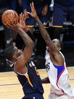 The Utah Jazz's Joe Johnson scores over the Clippers' Jamal Crawford and DeAndre Jordan  to win Game 1.
