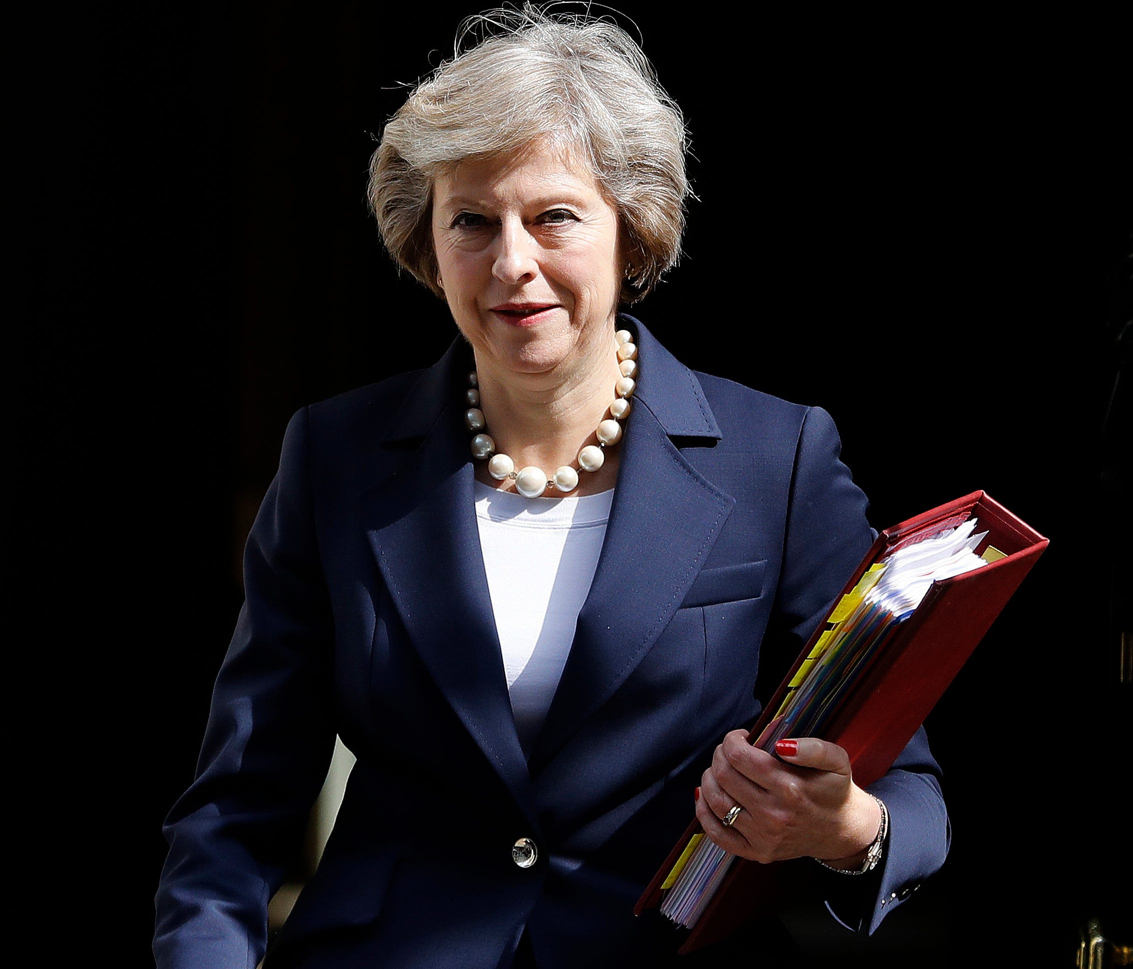 In this Wednesday, July 20, 2016 file photo, Britain's Prime Minister Theresa May leaves 10 Downing Street to attend her first Prime Minister's Questions at the House of Parliament in London.