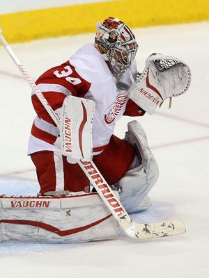 Red Wings goalie Petr Mrazek is hit by the puck under his neck protector during the third period of the Wings' 4-1 loss Tuesday in Winnipeg, Manitoba.