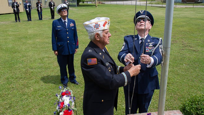 The color guard lowers the flag to half staff during the 18th annual Memorial Day observance at Hollywood Cemetery in this May 2015 file photo.