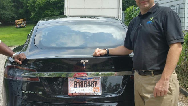 Joshua Brown stands by his new Tesla electric car near his home in Canton, Ohio in 2015.