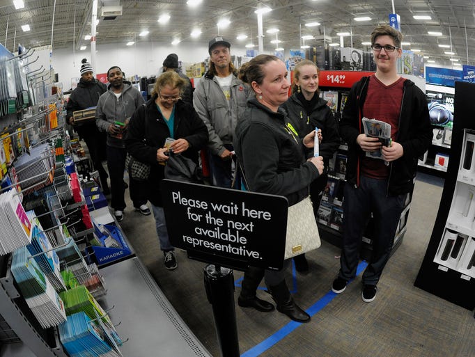 Shoppers wait in line to pay for their Black Friday