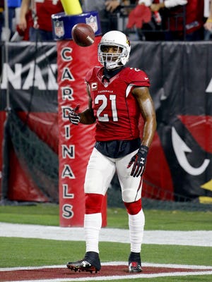 Patrick Peterson of the Cardinals flips the ball after he ran an interception back for a touchdown only for it to be called back due to a Cardinals penalty resulting in the ball going back to the Packers during the second quarter of the NFC Divisional playoff game at the University of Phoenix Stadium in Glendale, Az., on Saturday, January 16, 2016.