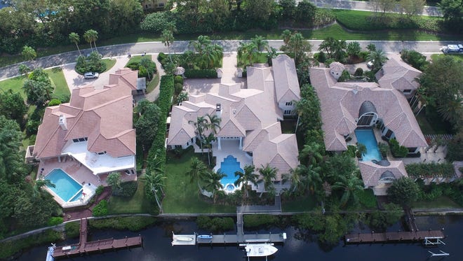 The featured property of the month, at 2763 Calais Drive in Palm Beach Gardens, offers 127 linear feet of water frontage, as seen in this aerial photo.