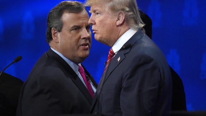 Chris Christie, left, and Donald Trump talk during a break in the CNBC Republican presidential debate at the University of Colorado, Wednesday, Oct. 28, 2015, in Boulder, Colo. A new poll shows Christie far behind Trump among Republicans in his home state of New Jersey. (AP Photo/Mark J. Terrill)