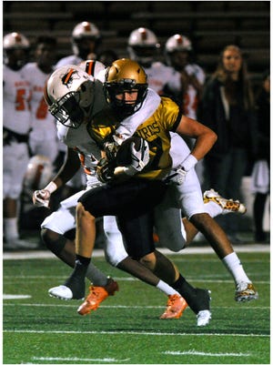 Abilene High School wide receiver Wes Berry gets wrapped-up by Haltom High School Imiee Cooksey during Friday's game Sept. 29, 2017. Abilene lost, 35-36.