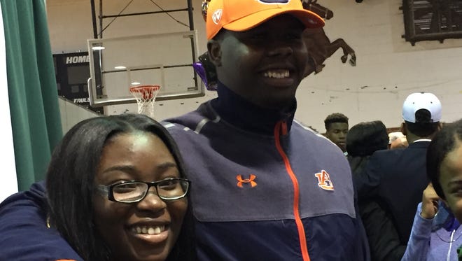 Jeff Davis defensive lineman Alec Jackson and Carlmesha Miles were all smiles after he signed with Auburn on Wednesday.