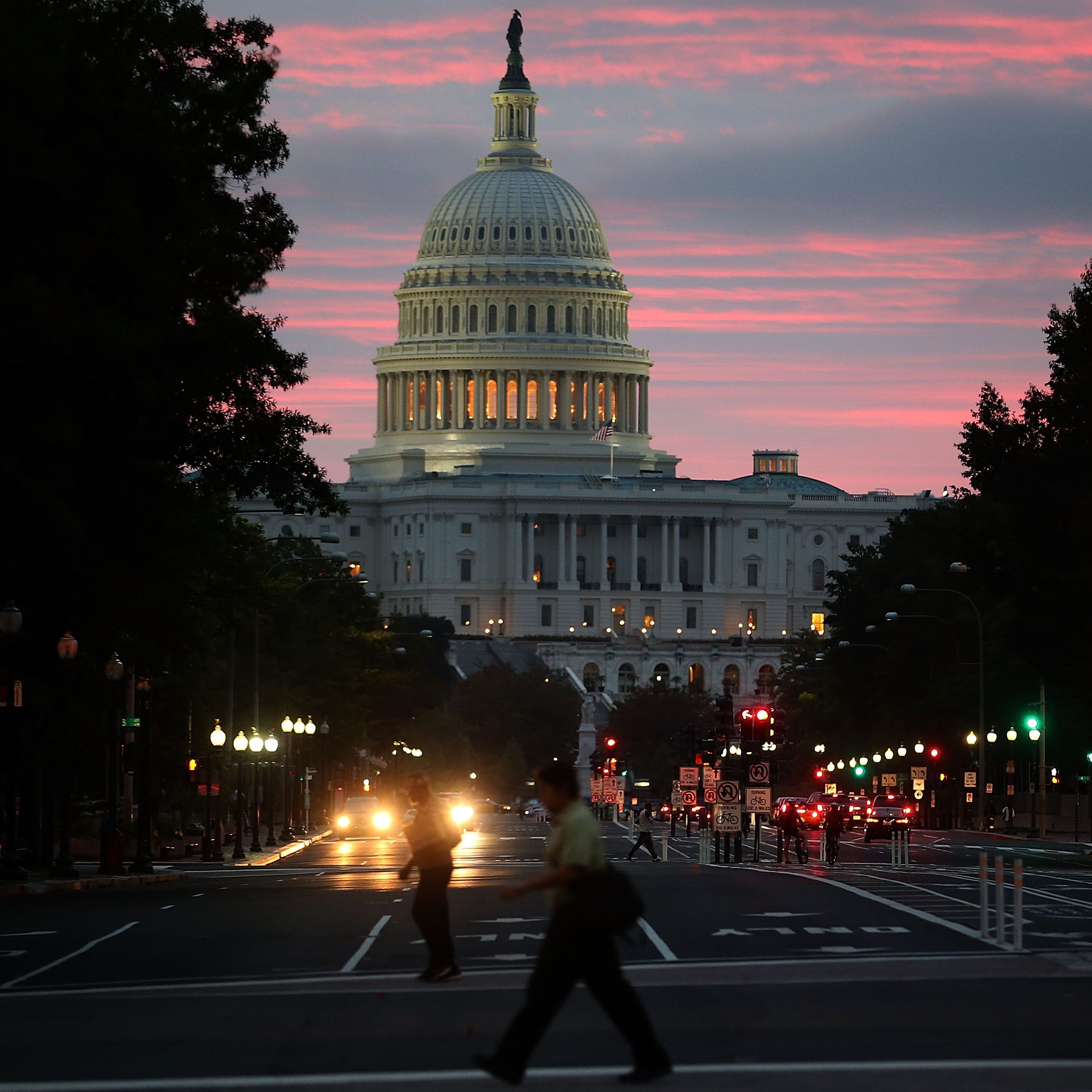 WASHINGTON, DC - OCTOBER 17:  The sun begins to rise behind the U.S. Capitol building on the morning after a bipartisan bill was passed by the House and the Senate to reopened the government and raise the debt limit, on October 17, 2013 in Washington, DC. President Obama signed the bill into law, that will fund the government until January 15, 2014 and allow the government to pay bills until February 7, 2014.  (Photo by Mark Wilson/Getty Images)