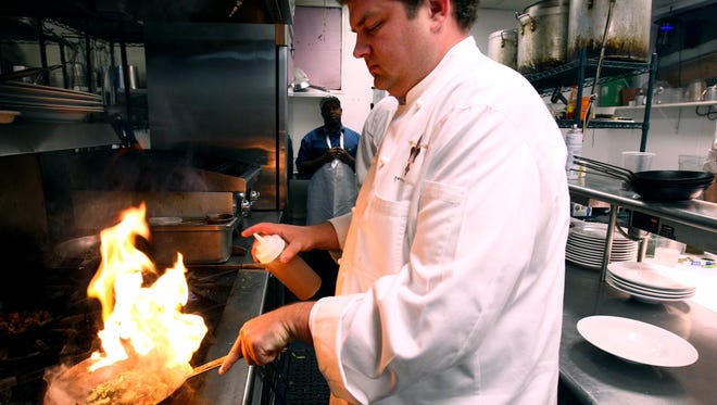 Kelly English prepares brussels sprouts at Restaurant Iris.