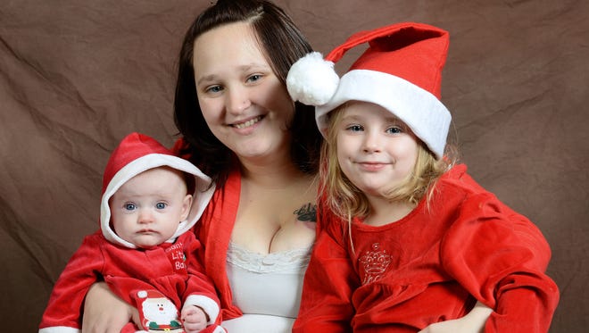 House of Hope graduate Tabitha Krauss (center) and her two children Ember, 3 months, and Cloe, 4, photographed in the Press-Gazette's studio in Green Bay, Wis. on Monday, Dec. 15, 2014.