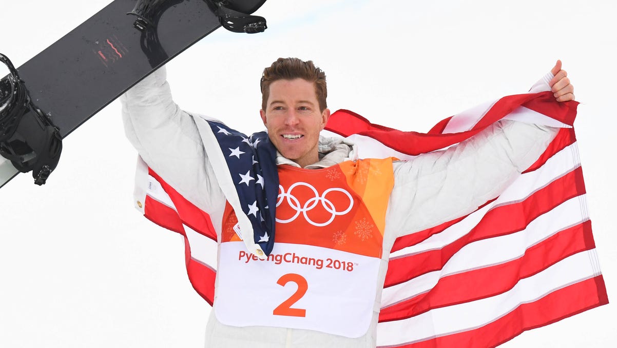 Shaun White (USA) celebrates winning gold in the men's snowboard halfpipe.